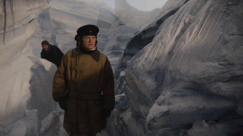 a screenshot from AMC's The Terror season 1. Francis Crozier stands in a corridor of ice, while one of his men follows behind him.
